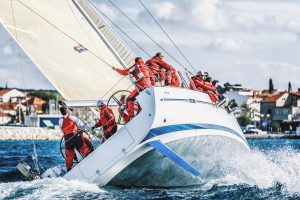 Sailing crew on sailboat during regatta